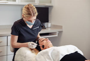 Patient receiving laser genesis treatment at Kingsway Dermatology in Toronto