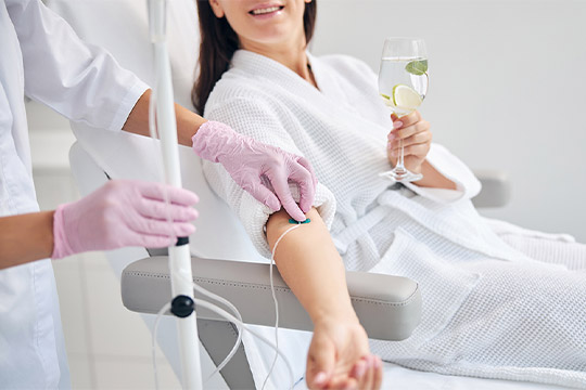 woman getting an IV therapy while relaxing at Kingsway Dermatology